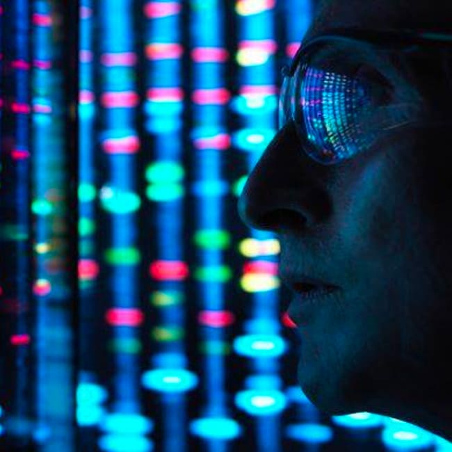 Person in glasses looking at digital coding