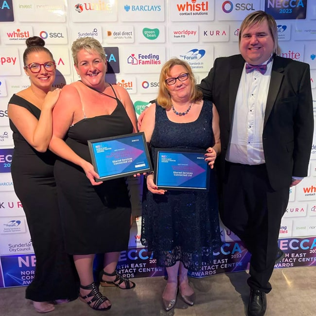 Four of SSCL’s contact centre services team at the NECCA 2023 Awards holding two awards